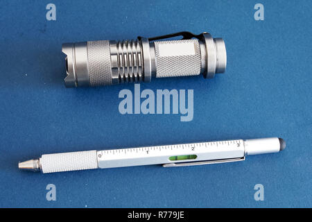 Products from aluminum, a flashlight and a writing pen Stock Photo
