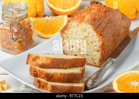 Homemade orange fruit loaf cake with citrus candied fruits and nuts.  Traditional treat for tea for Breakfast. Pound cake. Selective focus Stock Photo