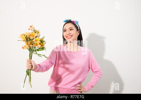 Lifestyle leisure international women's day concept. Close up portrait of lovely cute adorable excited delightful attractive woman holding flowers iso Stock Photo