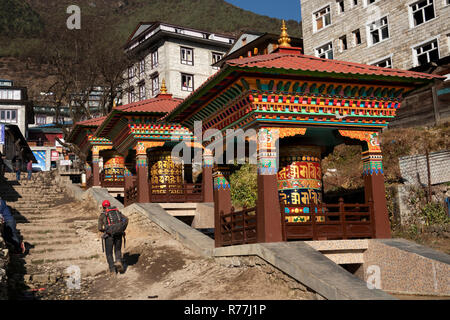 Nepal, Namche Bazar, colourful water-powered Buddhist prayer wheels beside main path into town Stock Photo