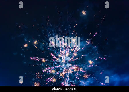 Bright festive fireworks against the background of the blue night sky Stock Photo