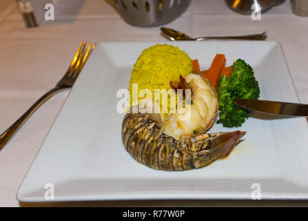 Lobster with sauce and vegetables on plate. Stock Photo