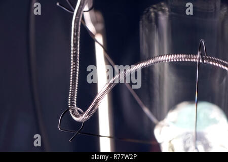 Tungsten filament in an incandescent lamp, macro photo. Stock Photo