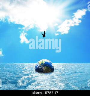 Globe floating on sea Stock Photo