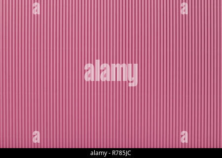 Texture of corrugated light pink paper, macro. Striped pattern of rose cardboard background, closeup. Stock Photo