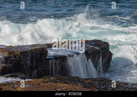 Waves breaking over the rocks at Hermanus, Cape, South Africa. Stock Photo