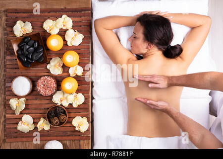 Close-up Of Therapist Hand Massaging Woman's Back In Spa Stock Photo