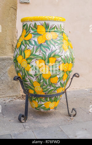 Ceramic jar decorated with lemons on a foot Stock Photo