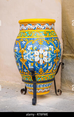 Ceramic jar decorated with floral motifs placed on a foot Stock Photo