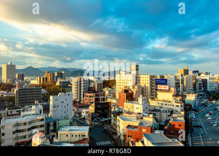 Mishima, Shizuoka / Japan - December 1 2018: Mishima modern city centre near JR railway station dense buildings with mountains in background Stock Photo