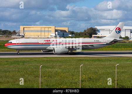 China Eastern Airlines Airbus A330-343 entering runway 31 for take off. Stock Photo