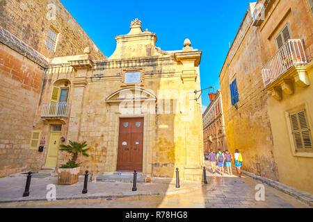 MDINA, MALTA - JUNE 14, 2018: The small St Agatha Chapel embedded with neighbor buildings, located in medieval Mdina fortress, on June 14 in Mdina, Ma Stock Photo