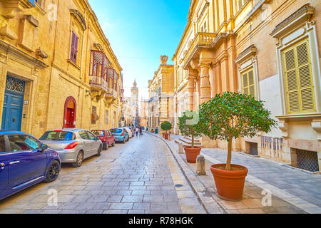 MDINA, MALTA - JUNE 14, 2018: The wide medieval street in Mdina fortress with beautiful decorated edifices, stretch along it, on June 14 in Mdina Stock Photo