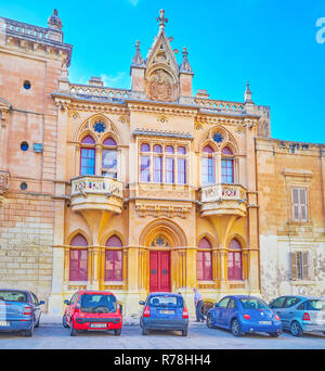 MDINA, MALTA - JUNE 14, 2018: The beautiful building with unusual frontage, decorated with smooth elements, located on St Paul Square, on June 14 in M Stock Photo