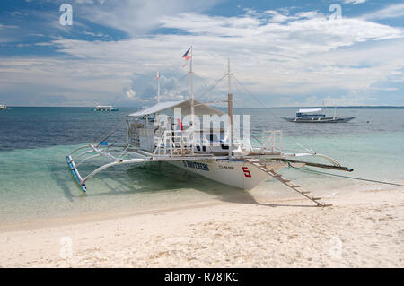 Bangca, traditional Philippine outrigger canoe, off Gato Island, Bohol ...