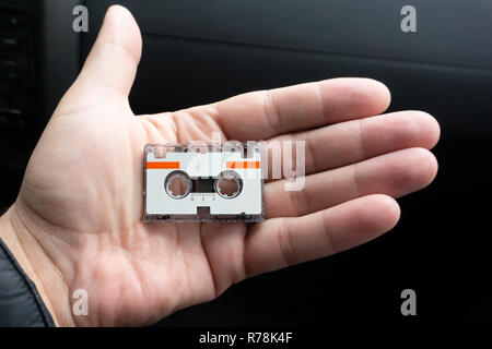 Micro audio cassette on hand background cut Stock Photo