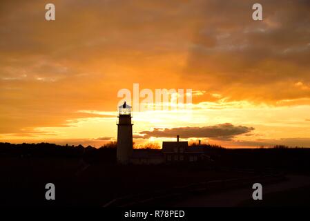 A silohuette of the Highland or Cape Cod Lighthouse at sunset in Cape Cod Massachusetts. Stock Photo