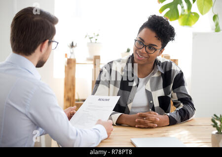 Male employer interview smiling black female applicant Stock Photo
