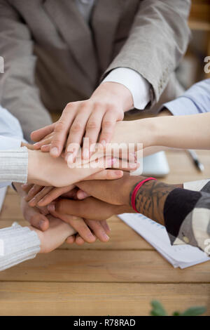 Close up of diverse people put hands in stack  Stock Photo