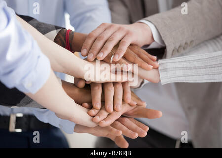 Close up of diverse people put hands in stack Stock Photo