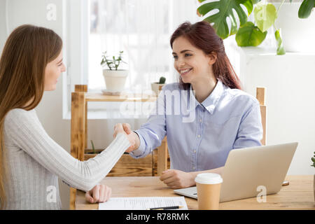 Smiling woman handshake candidate during office interview Stock Photo