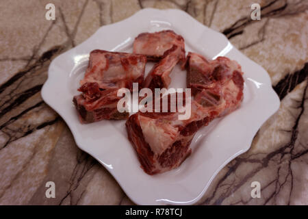 Raw beef meal in bowl, fresh, natural food for dog or cat, isolated on white background. Top view Stock Photo