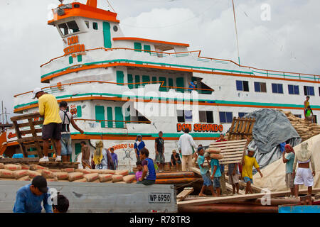 Workers load riverboats at the Amazon river in Iquitos,Peru Stock Photo