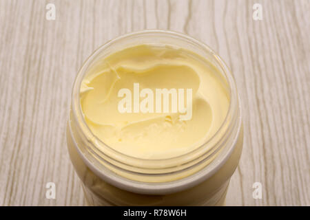 Mayonnaise in round dish isolated on white background, top view Stock Photo