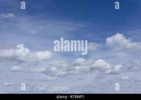 Wavy porous curly clouds on the blue sky Nature background Stock Photo