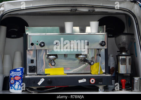 Coffee espresso extraction from professional machine and Barista with milk filter . Russia Berezniki 30 June 2018 Stock Photo