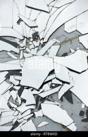 The shards of a smashed mirror lying on the ground Stock Photo