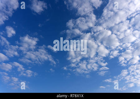 amazing white clouds of unusual shape on blue sky background Stock Photo