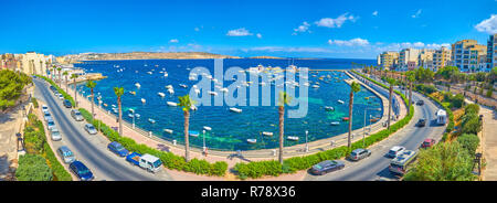 BUGIBBA, MALTA - JUNE 14, 2018: The panoramic view on the St Paul's Bay of Bugibba resort with small fishing harbour and seaside promenade, on June 14 Stock Photo