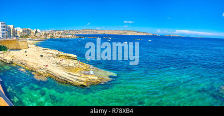 BUGIBBA, MALTA - JUNE 14, 2018: The rocky shore is the special characteristic of resort's coastline, on June 14 in Bugibba. Stock Photo