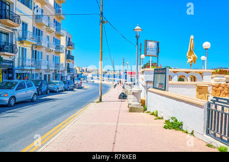 BUGIBBA, MALTA - JUNE 14, 2018: Popular Dawret Il-Gzejjer Promenade is full of ice cream shops and cafes, offering cool beverages and fresh juice, on  Stock Photo