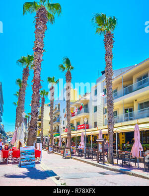 BUGIBBA, MALTA - JUNE 14, 2018: The Pjazza Walkway is the heart of resort with the most popular cafes and restaurants, offering tasty local food and b Stock Photo