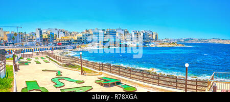 BUGIBBA, MALTA - JUNE 14, 2018: The small golf course for beginners located at the shoreline of the resort, on June 14 in Bugibba. Stock Photo