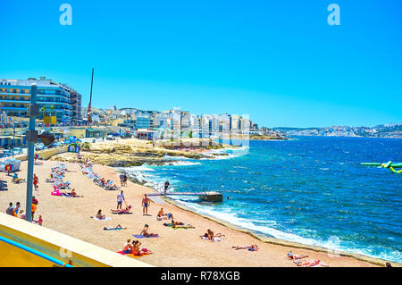 BUGIBBA, MALTA - JUNE 14, 2018: The Bugibba Perched Beach is one of the best in the city with special platform and ladder to the sea, on June 14 in Bu Stock Photo