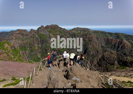 Tourists enjoy the stunning views from the the Pico do Areeiro viewpoint in the central mountains of the Portugese island of Madeira Stock Photo