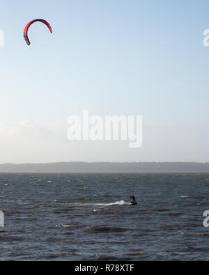 A lone Kite surfer on UK waters in winter Stock Photo