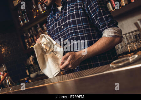 Bartender Standing at Bar Counter, Cleaning Glasses with Towel Stock Photo  - Image of portrait, informal: 190411966