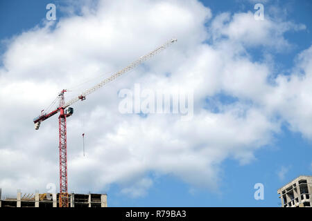 Big hoisting tower crane and top section of modern