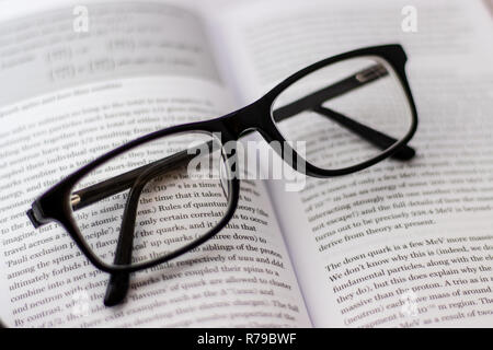 Pair of black glasses lying around on white background Stock Photo