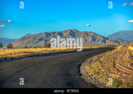 Curving road with West Mountain in the horizon Stock Photo