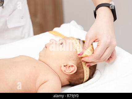 Doctor measuring baby head circumference. Pediatrician place