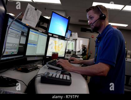 JACKSONVILLE, Fla. (April 12, 2017) Jason Solomon, a Navy Region Southeast 911 emergency dispatcher, works at his multiscreen station in the Navy Region Southeast Regional Dispatch Center. The RDC currently dispatches fire and security personnel for 14 installations. Stock Photo