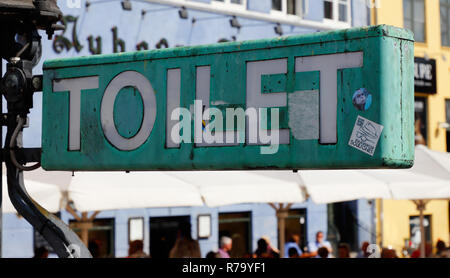 Copenhagen, Denmark - August 24, 2017: Close-up view of a green toilet sign in the Nyhavn area. Stock Photo