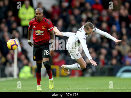Manchester United's Ashley Young (left) and Fulham's Andre Schurrle battle for the ball during the Premier League match at Old Trafford, Manchester. Stock Photo