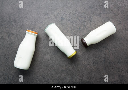 Milk bottle on dark stone background. Top view Stock Photo