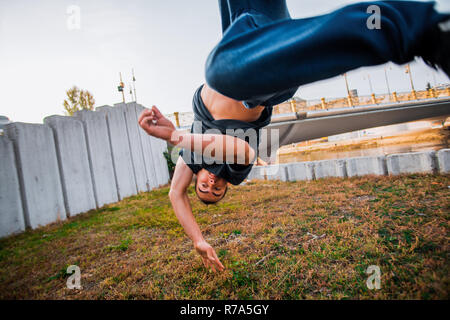 Young man practicing parkour while jumping in park Stock Photo
